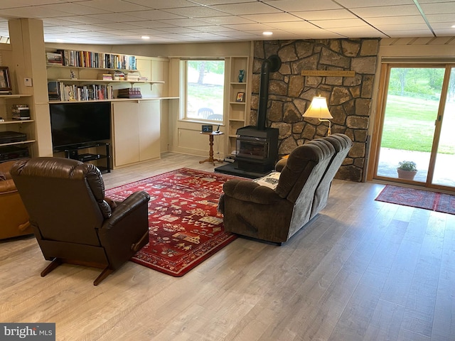 108 Wright St SE, Frostburg, MD 21532 - living room featuring a wood stove, plenty of natural light, wood finished floors, and a drop ceiling