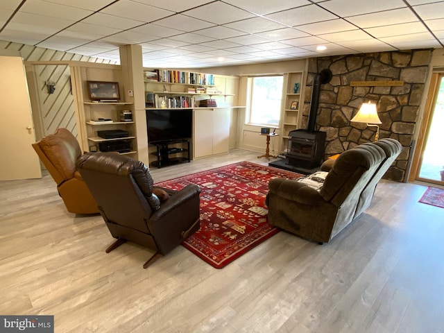 108 Wright St SE, Frostburg, MD 21532 - living area featuring a wood stove, light wood-style floors, and a drop ceiling