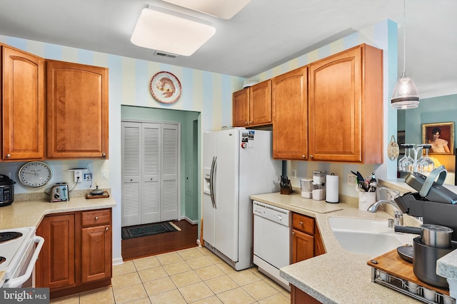 8145 Cyprus Cedar Ln Unit C, Ellicott City, MD 21043 - kitchen featuring white appliances, a sink, light tile patterned floors, and light countertops