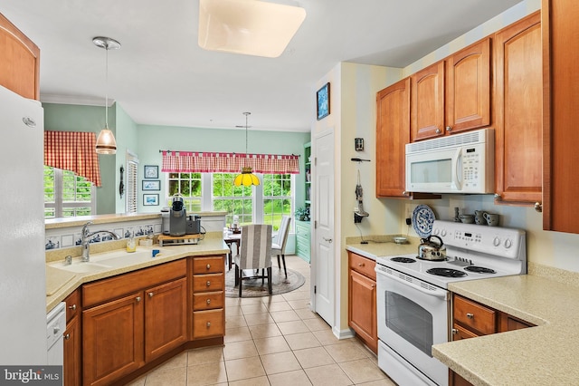 8145 Cyprus Cedar Ln Unit C, Ellicott City, MD 21043 - kitchen with white appliances, a sink, light countertops, light tile patterned flooring, and hanging light fixtures