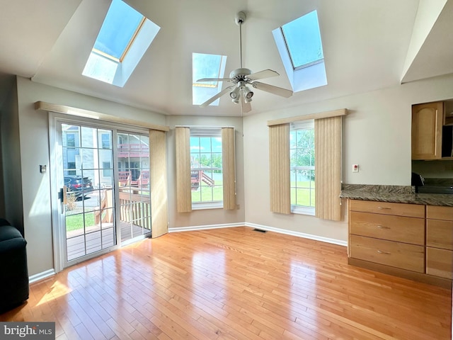 55 W Windrose Dr, Richboro, PA 18954 - unfurnished living room with a skylight, lofted ceiling, a ceiling fan, light wood-style flooring, and healthy amount of natural light
