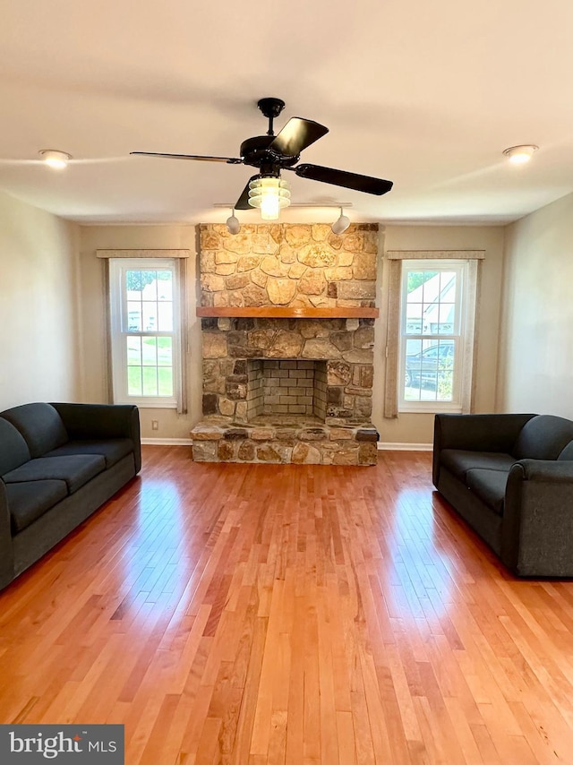 55 W Windrose Dr, Richboro, PA 18954 - living room with wood-type flooring, ceiling fan, baseboards, and a fireplace