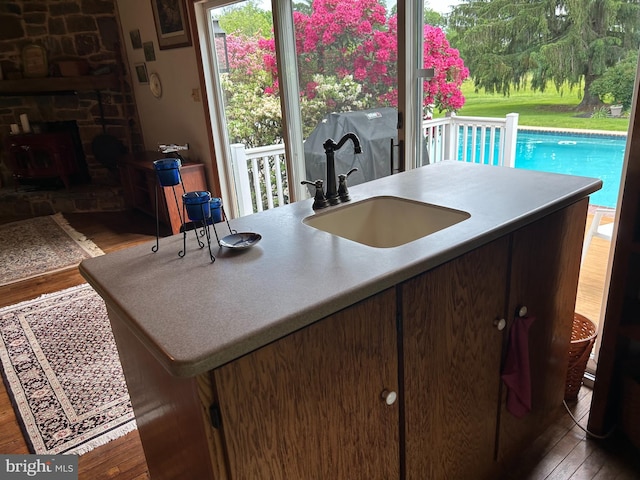 1132 Upper Stump Rd, Chalfont, PA 18914 - kitchen featuring wood finished floors, a sink, and a fireplace