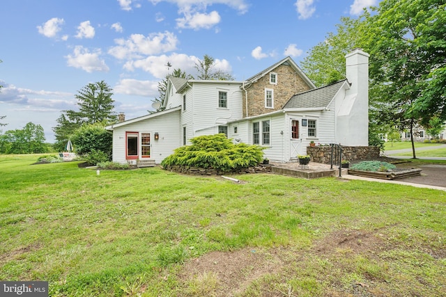1132 Upper Stump Rd, Chalfont, PA 18914 - back of property featuring a chimney, a yard, stone siding, and entry steps