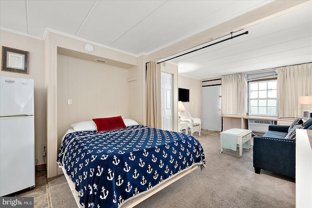 3010 Philadelphia Ave Unit S106, Ocean City, MD 21842 - bedroom featuring freestanding refrigerator, crown molding, carpet flooring, and a wall mounted air conditioner