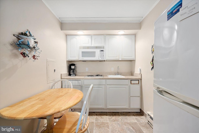 3010 Philadelphia Ave Unit S106, Ocean City, MD 21842 - kitchen featuring white appliances, a sink, ornamental molding, white cabinets, and light countertops