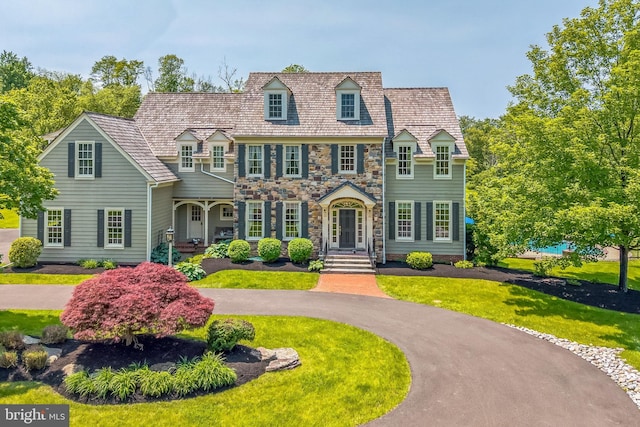 1293 Eagle Rd, New Hope, PA 18938 - view of front of house featuring a front yard, stone siding, and a high end roof