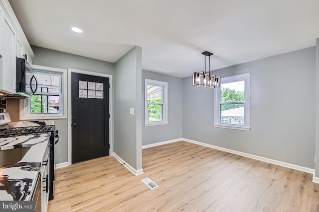 1235 Delbert, Baltimore, MD 21222 - foyer featuring light wood-style floors, baseboards, a chandelier, and recessed lighting