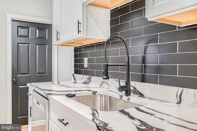 1235 Delbert, Baltimore, MD 21222 - kitchen with decorative backsplash, white cabinetry, a sink, and light stone countertops