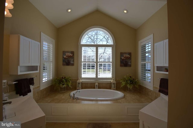 35517 Bonaire Dr, Rehoboth Beach, DE 19971 - bathroom with a bath, healthy amount of natural light, lofted ceiling, and recessed lighting