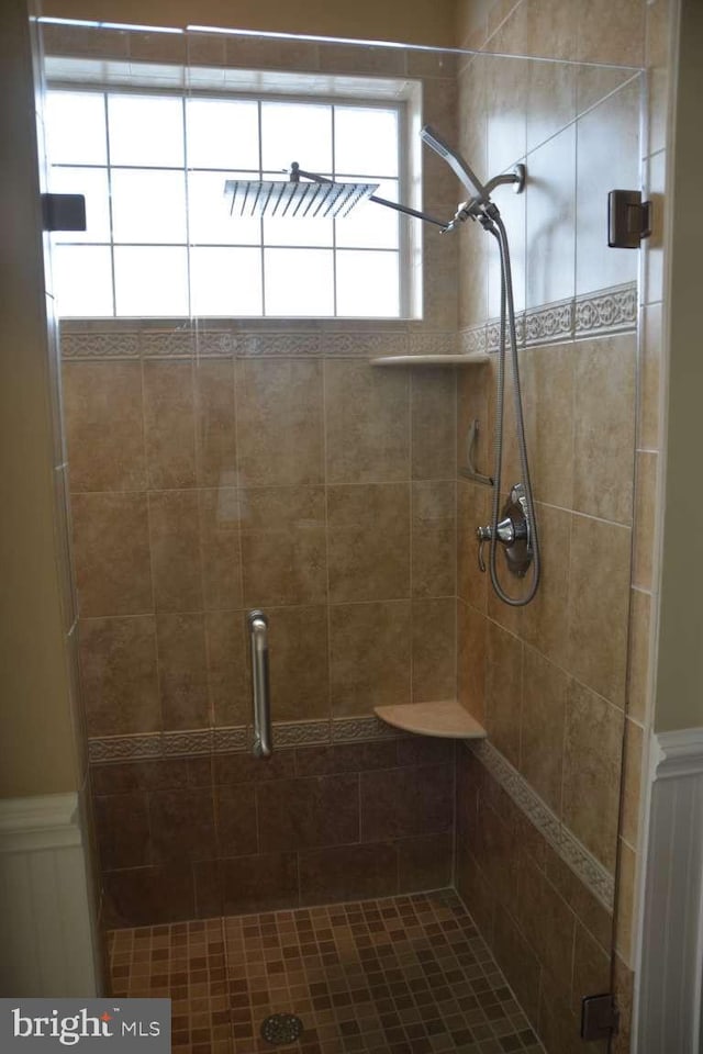35517 Bonaire Dr, Rehoboth Beach, DE 19971 - full bathroom featuring a shower stall, a wainscoted wall, and a decorative wall