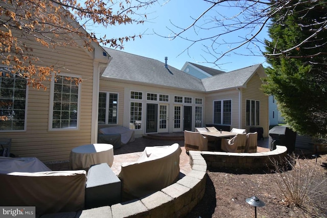 35517 Bonaire Dr, Rehoboth Beach, DE 19971 - back of property with french doors, a patio area, roof with shingles, and outdoor lounge area