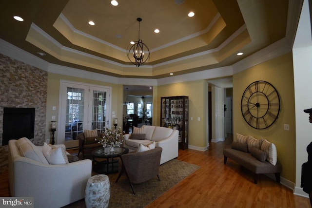 35517 Bonaire Dr, Rehoboth Beach, DE 19971 - living room with a tray ceiling, crown molding, wood finished floors, recessed lighting, and baseboards