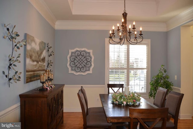 35517 Bonaire Dr, Rehoboth Beach, DE 19971 - dining room with a chandelier, plenty of natural light, wainscoting, wood finished floors, and crown molding