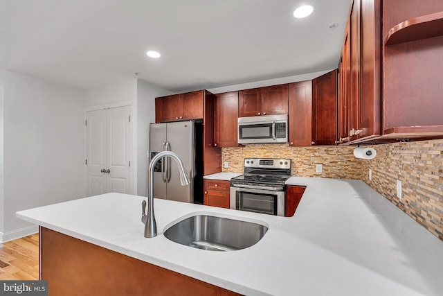 821 N 15th St Unit 2, Philadelphia, PA 19130 - kitchen featuring stainless steel appliances, light countertops, a sink, backsplash, and recessed lighting