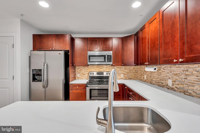 821 N 15th St Unit 2, Philadelphia, PA 19130 - kitchen featuring appliances with stainless steel finishes, dark brown cabinets, light countertops, backsplash, and recessed lighting