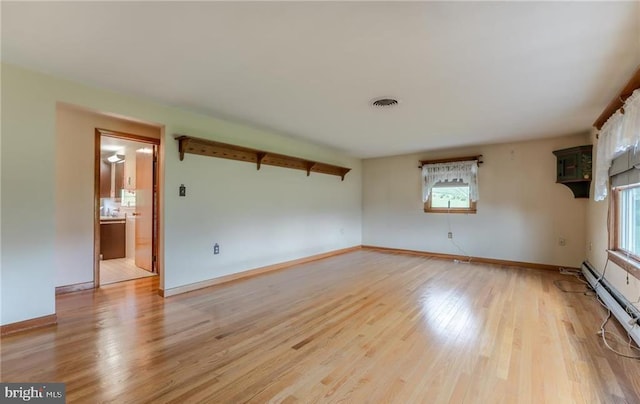 1195 Hemlock St, Palmerton, PA 18071 - empty room featuring plenty of natural light, light wood-style floors, baseboards, and baseboard heating
