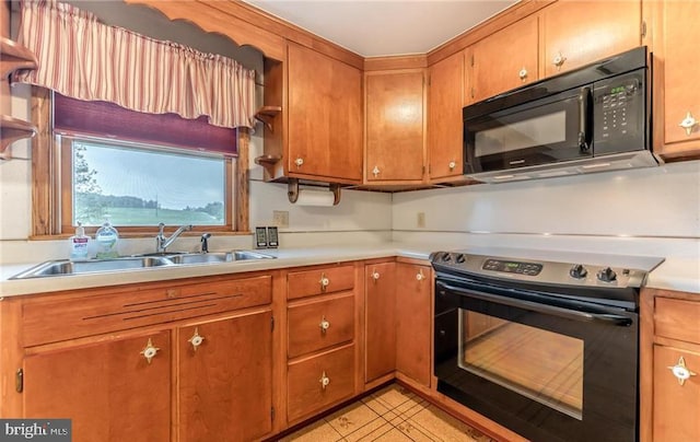 1195 Hemlock St, Palmerton, PA 18071 - kitchen featuring black appliances, a sink, light countertops, and brown cabinetry