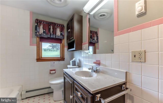 1195 Hemlock St, Palmerton, PA 18071 - bathroom with tile walls, a baseboard heating unit, toilet, vanity, and a bath