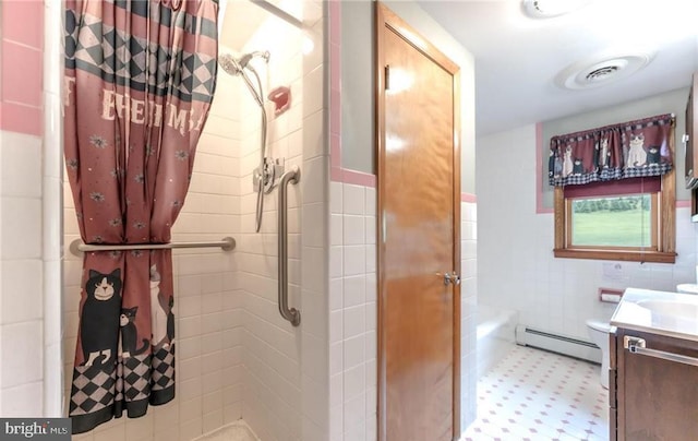1195 Hemlock St, Palmerton, PA 18071 - bathroom featuring a baseboard heating unit, tile walls, a tile shower, vanity, and a wainscoted wall