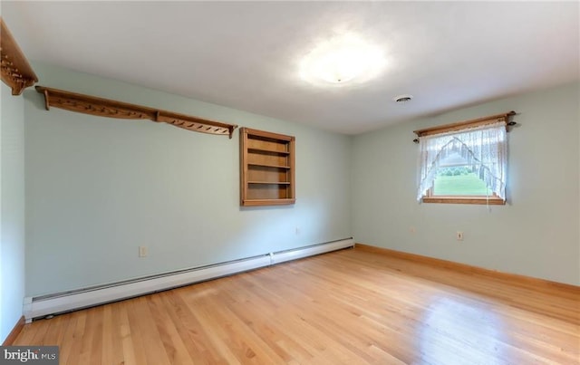 1195 Hemlock St, Palmerton, PA 18071 - spare room featuring baseboard heating, wood finished floors, and baseboards