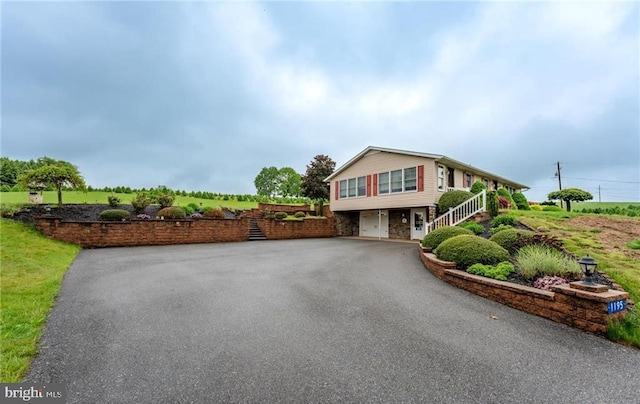 1195 Hemlock St, Palmerton, PA 18071 - view of front of property featuring stairs, stone siding, asphalt driveway, and an attached garage
