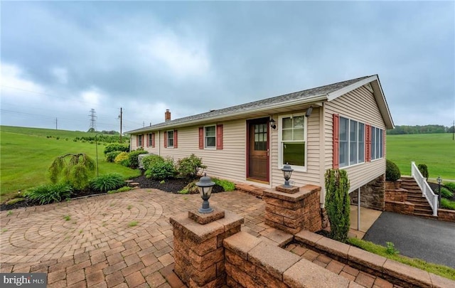 1195 Hemlock St, Palmerton, PA 18071 - view of front of house featuring a patio, a front lawn, a chimney, and stairway