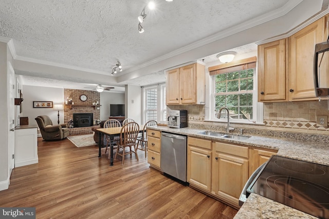 4549 Diehl Ct, Woodbridge, VA 22193 - kitchen featuring stainless steel dishwasher, range with electric stovetop, a textured ceiling, a sink, and a fireplace
