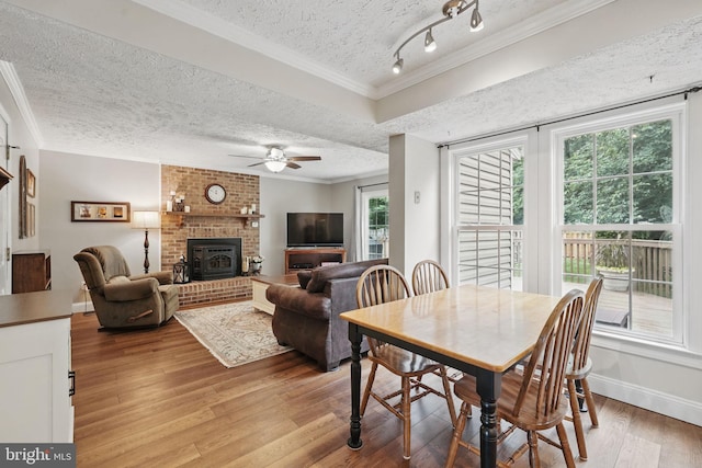 4549 Diehl Ct, Woodbridge, VA 22193 - dining room with a textured ceiling, light wood-type flooring, a ceiling fan, ornamental molding, and a wood stove