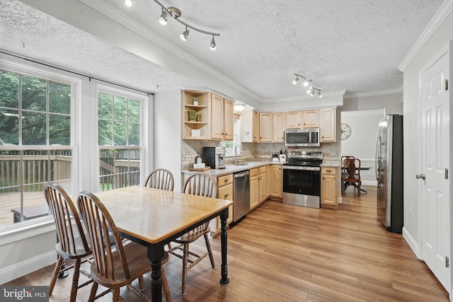 4549 Diehl Ct, Woodbridge, VA 22193 - kitchen featuring appliances with stainless steel finishes, light brown cabinetry, a sink, light wood-type flooring, and crown molding