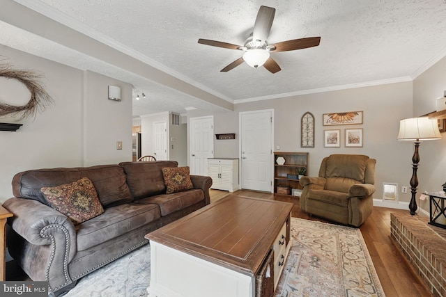4549 Diehl Ct, Woodbridge, VA 22193 - living area with ceiling fan, a textured ceiling, light wood-style floors, crown molding, and baseboards