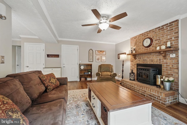 4549 Diehl Ct, Woodbridge, VA 22193 - living area featuring light wood-type flooring, a ceiling fan, a textured ceiling, a wood stove, and ornamental molding