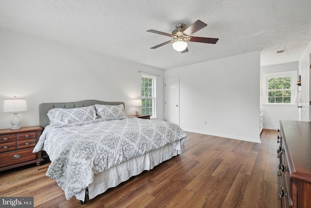 4549 Diehl Ct, Woodbridge, VA 22193 - bedroom featuring wood finished floors, a textured ceiling, baseboards, and a ceiling fan