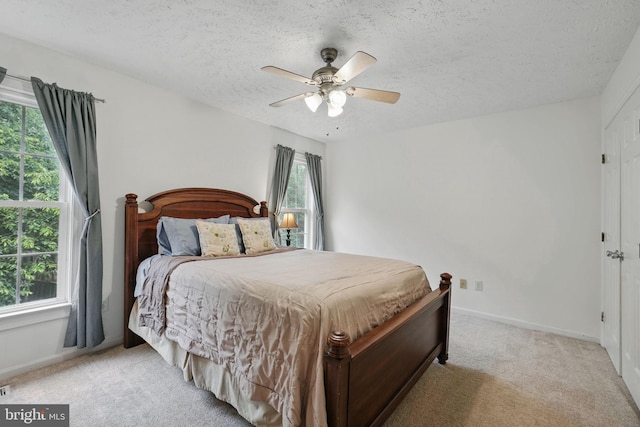 4549 Diehl Ct, Woodbridge, VA 22193 - bedroom featuring light carpet, a textured ceiling, a ceiling fan, and baseboards