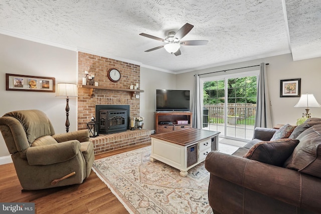 4549 Diehl Ct, Woodbridge, VA 22193 - living area featuring light wood-type flooring, ceiling fan, a textured ceiling, crown molding, and a wood stove