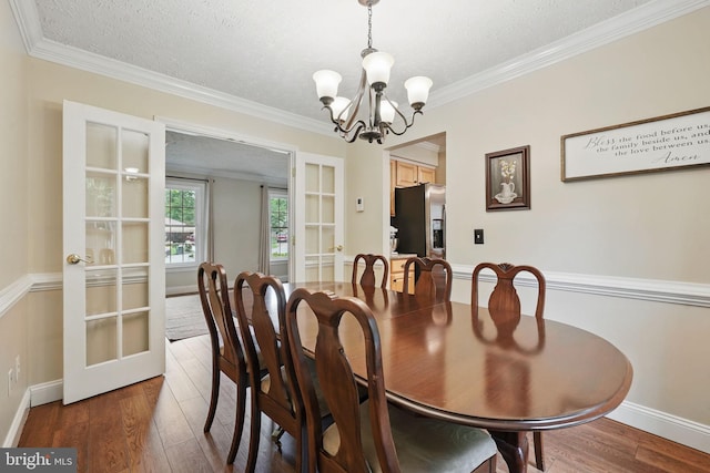 4549 Diehl Ct, Woodbridge, VA 22193 - dining area featuring french doors, a chandelier, wood finished floors, ornamental molding, and a textured ceiling
