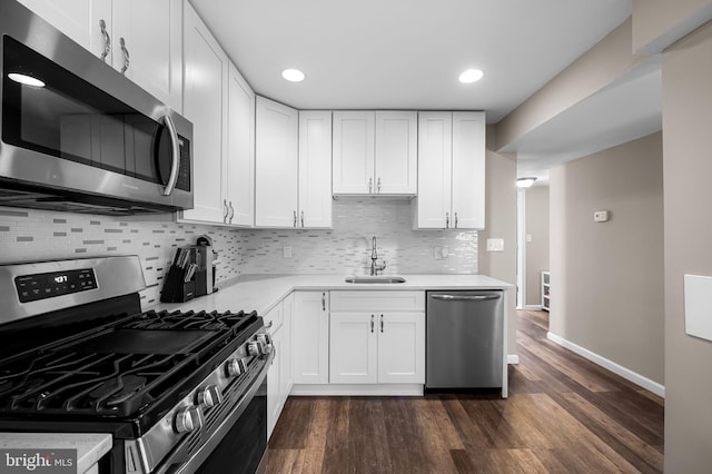 20 Village Rd, Baltimore, MD 21208 - kitchen with stainless steel appliances, light countertops, tasteful backsplash, white cabinetry, and recessed lighting