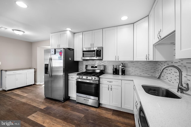 20 Village Rd, Baltimore, MD 21208 - kitchen with appliances with stainless steel finishes, white cabinets, backsplash, recessed lighting, and dark wood-type flooring