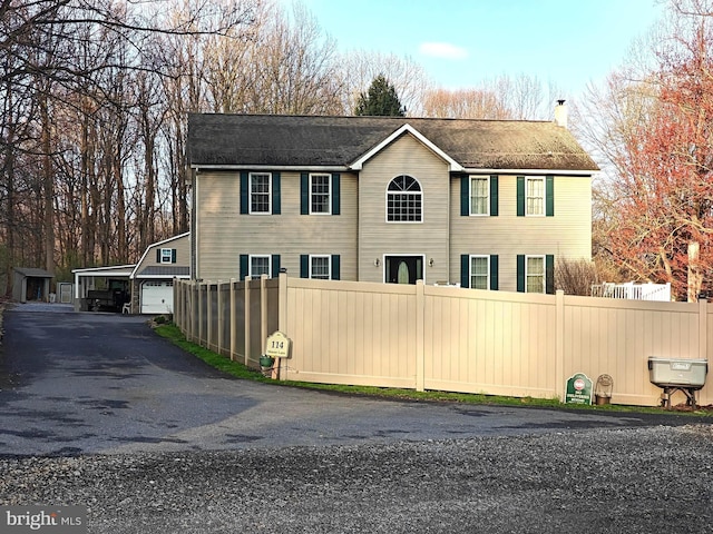 114 Moore Ln, Gap, PA 17527 - view of front of property with a garage, a chimney, driveway, and a shingled roof