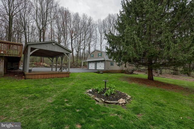 114 Moore Ln, Gap, PA 17527 - view of green lawn featuring a garage, a gazebo, a wooden deck, and asphalt driveway