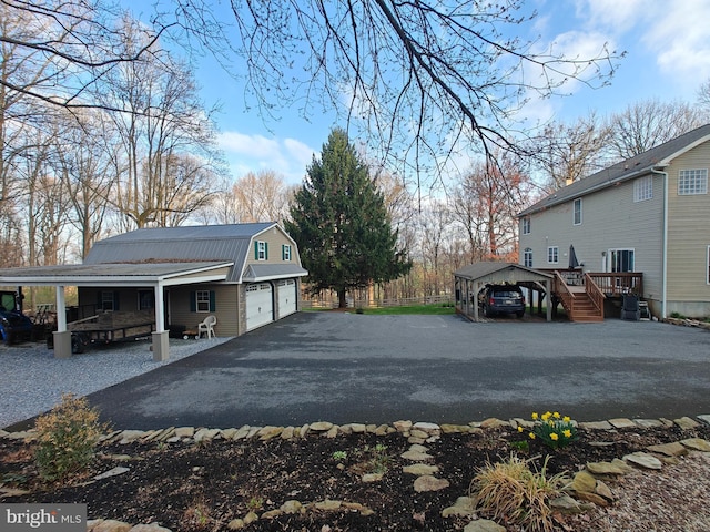 114 Moore Ln, Gap, PA 17527 - view of side of property featuring a gambrel roof, a porch, metal roof, a detached garage, and a carport