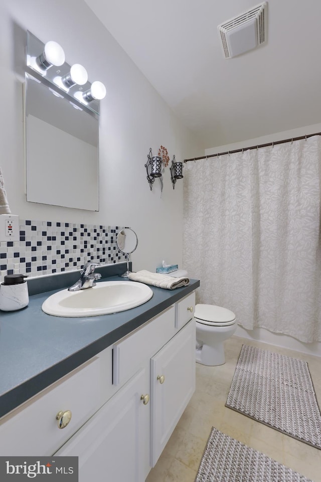 114 Moore Ln, Gap, PA 17527 - full bathroom featuring vanity, tasteful backsplash, toilet, and tile patterned floors