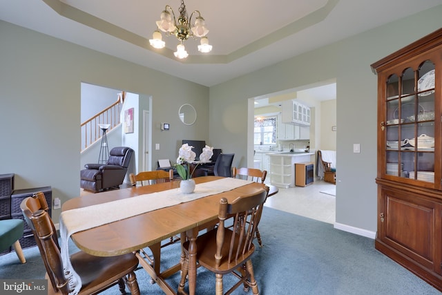 114 Moore Ln, Gap, PA 17527 - dining space with a chandelier, stairway, light carpet, and a tray ceiling