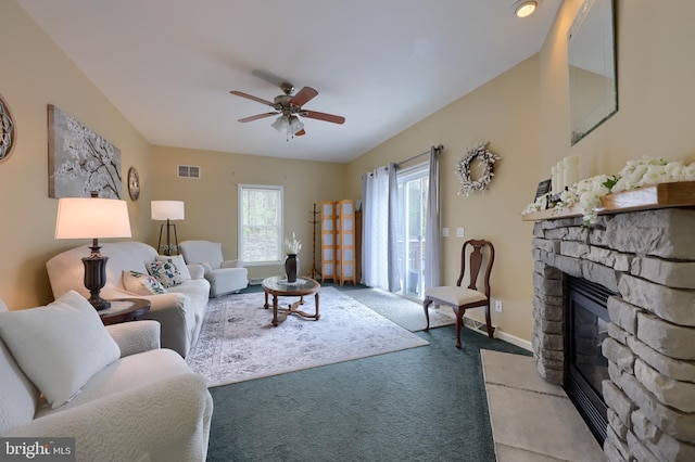 114 Moore Ln, Gap, PA 17527 - carpeted living room featuring a stone fireplace, ceiling fan, and baseboards