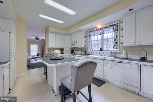 114 Moore Ln, Gap, PA 17527 - kitchen featuring white appliances, open shelves, white cabinetry, a sink, and a kitchen bar
