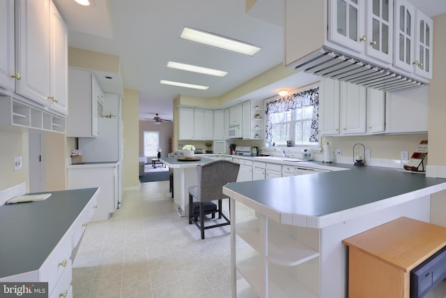 114 Moore Ln, Gap, PA 17527 - kitchen with open shelves, a peninsula, plenty of natural light, and white cabinets