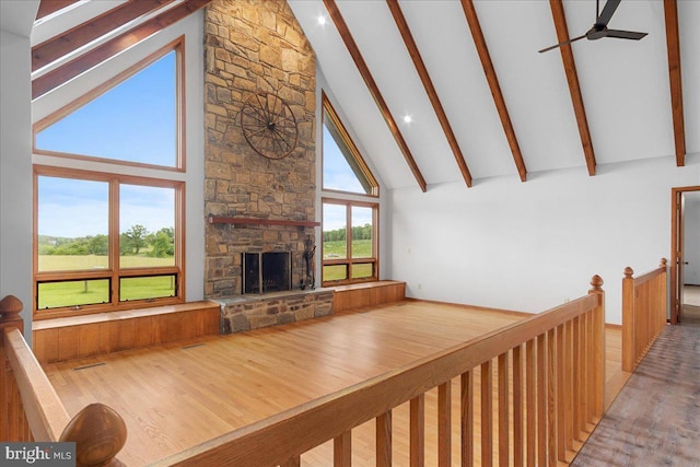 12549 Jesse Smith Rd, Mount Airy, MD 21771 - living room featuring high vaulted ceiling, beamed ceiling, a stone fireplace, ceiling fan, and wood finished floors