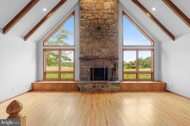 12549 Jesse Smith Rd, Mount Airy, MD 21771 - unfurnished living room featuring high vaulted ceiling, beamed ceiling, hardwood / wood-style flooring, healthy amount of natural light, and a stone fireplace