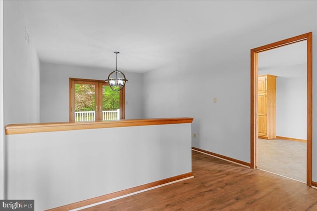 12549 Jesse Smith Rd, Mount Airy, MD 21771 - hallway with a chandelier, wood finished floors, and baseboards