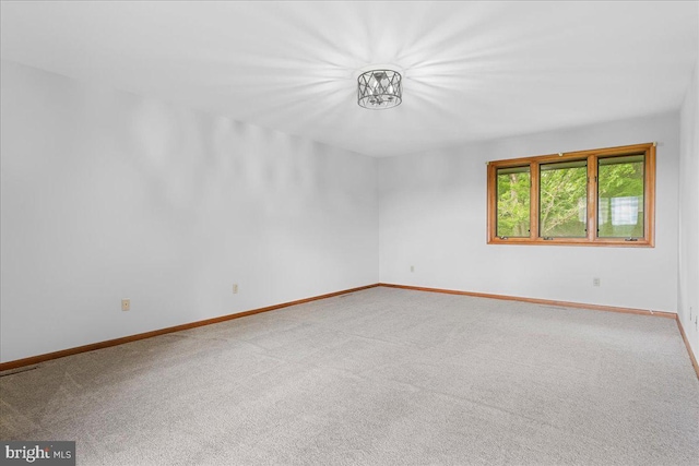 12549 Jesse Smith Rd, Mount Airy, MD 21771 - unfurnished room featuring carpet, baseboards, and a chandelier